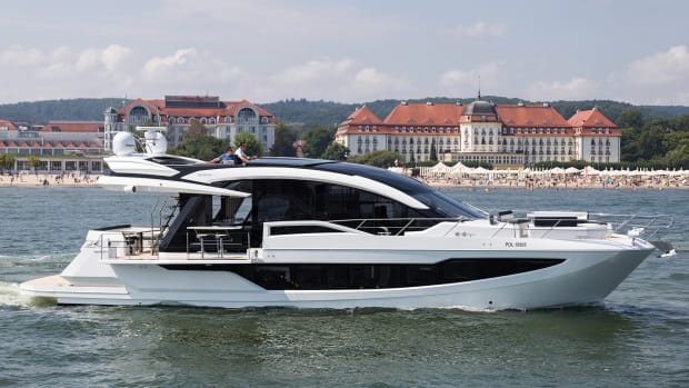 The Galeon 650 Skydeck cruises off the beachfront in the Baltic resort of Sopot. Note the side terrace and carbon top that closes off the flybridge.