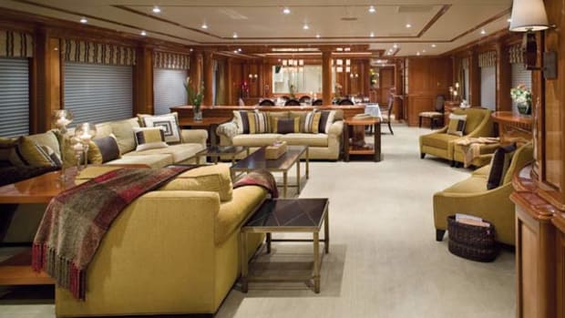 Look beyond the main saloon and past the dining room to the large, rectangular window in the far-left-hand corner of this space. It's a window into the galley and can be covered in a matching wood panel at the push of a button.