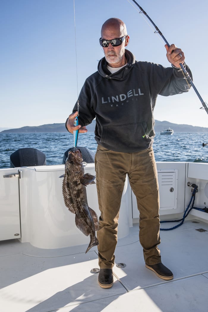 Lindell Yachts President Frank O’Neil shows off a lingcod he caught.