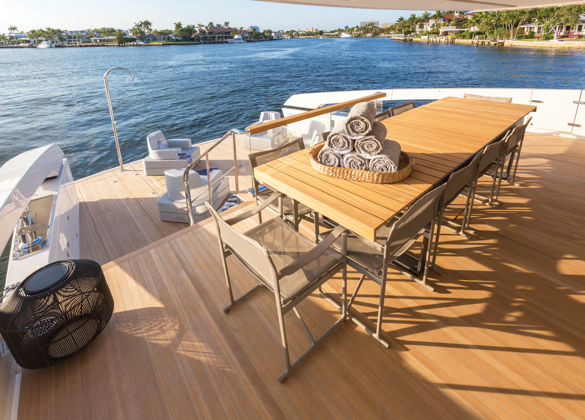 “Deliberately casual” is the term Lowe uses to describe the style of the SX88, and that atmosphere is achieved on the aft deck, with its oversized dining table (above) that overlooks the beach club (below), where there’s 323 square feet of space to keep guests close to the water. It’s very large for a boat in this size range.