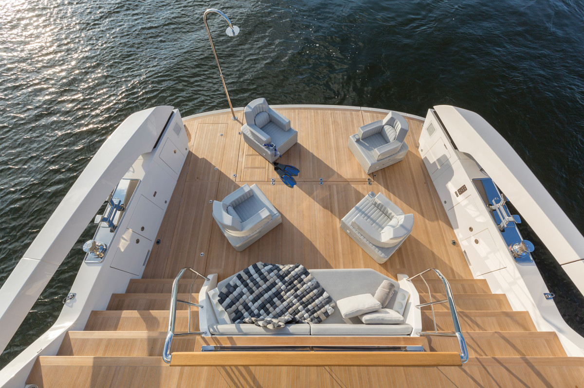 “Deliberately casual” is the term Lowe uses to describe the style of the SX88, and that atmosphere is achieved on the aft deck, with its oversized dining table (above) that overlooks the beach club (below), where there’s 323 square feet of space to keep guests close to the water. It’s very large for a boat in this size range.