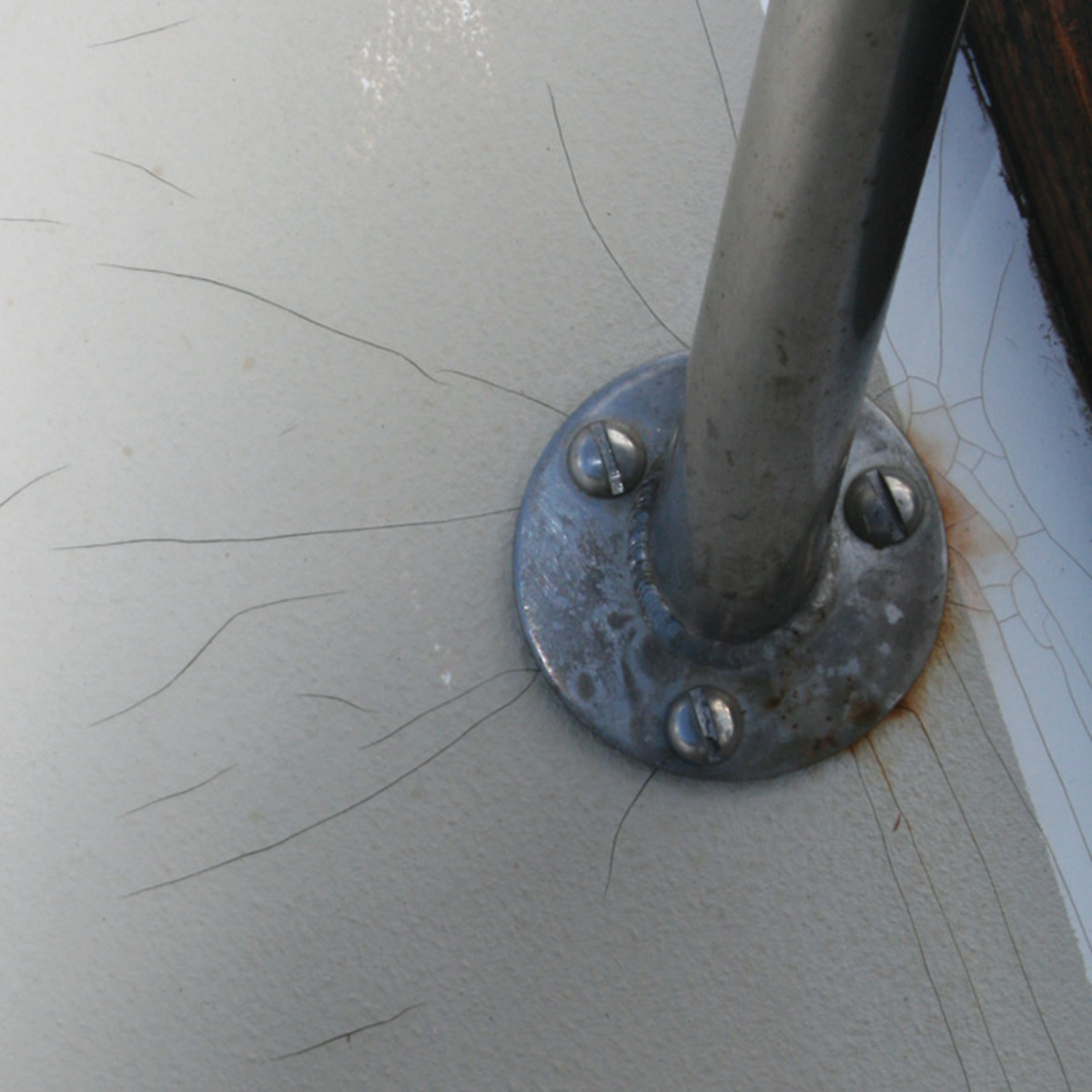 Stress cracks around stanchion bases are often compression-related.