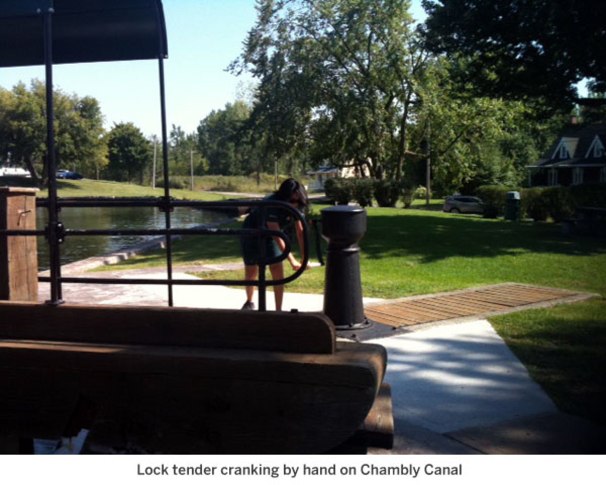 Lock tender cranking by hand on Chambly Canal