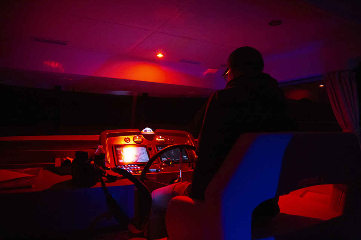 The author mans the helm of the Swift Trawler during his watch on the night run.