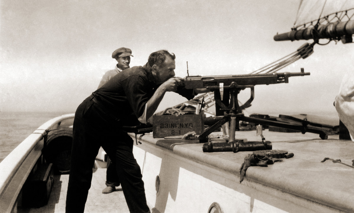 Bill McCoy (pictured aiming a Colt-Browning machine gun) protected the Arethusa with an array of weaponry sold surplus after the Armistice of 1918.
