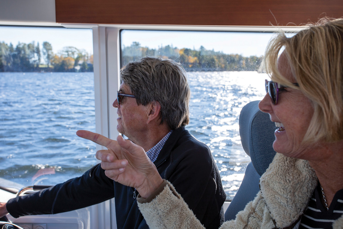 The cruising couple at the helm make good time aboard their outboard-powered C11.