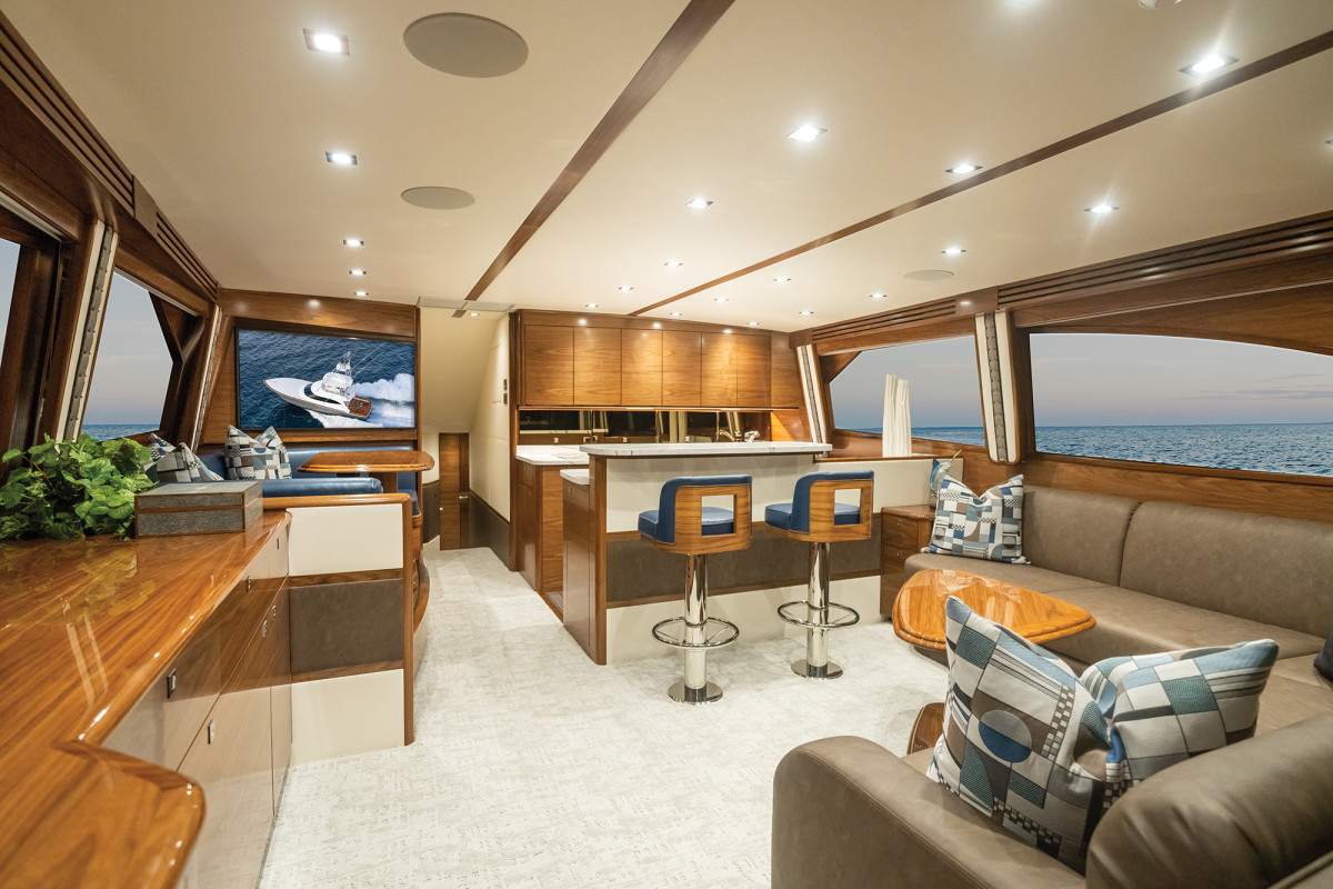 The interior of the Viking 64 is spacious with plenty of entertaining space and hidden storage, and it uses more contemporary wood patterns and textiles.
